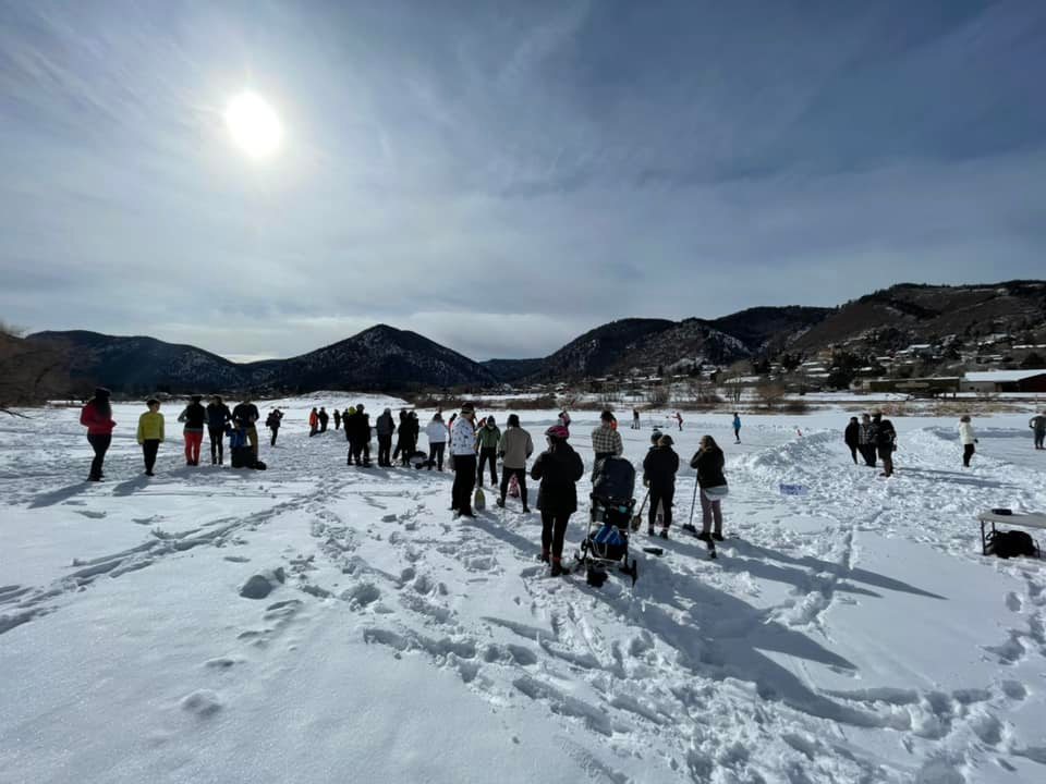 People standing on snowy, frozen lake