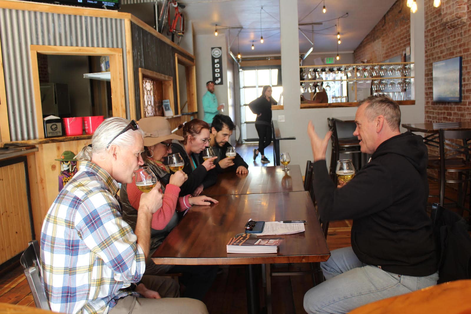 Image of people enjoy a beer at the Craft Brewery and Beer Tour