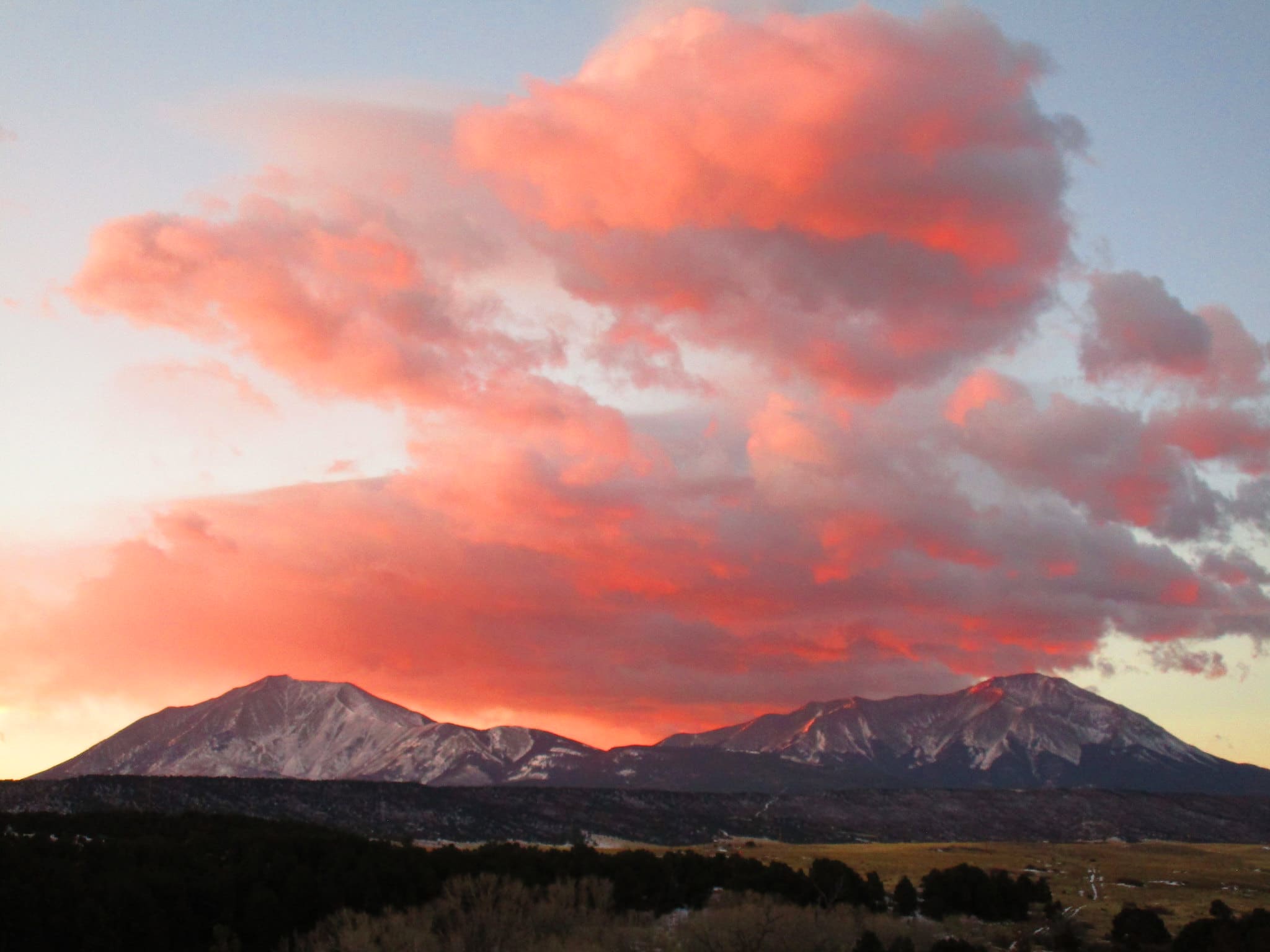 pink clouds and sunrise over mountains