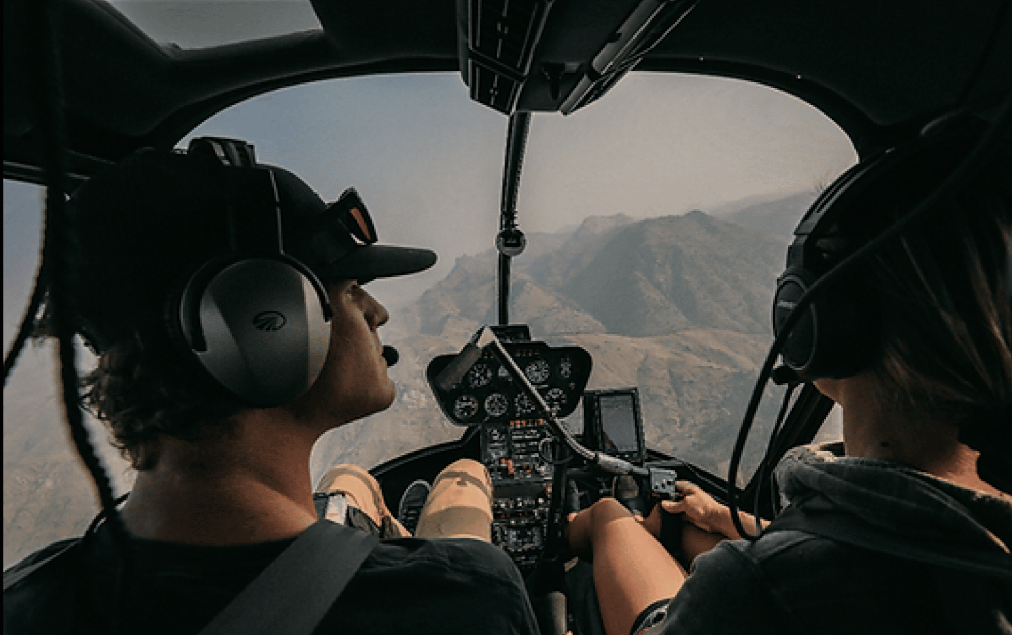 A pilot and passenger in helicopter cockpit