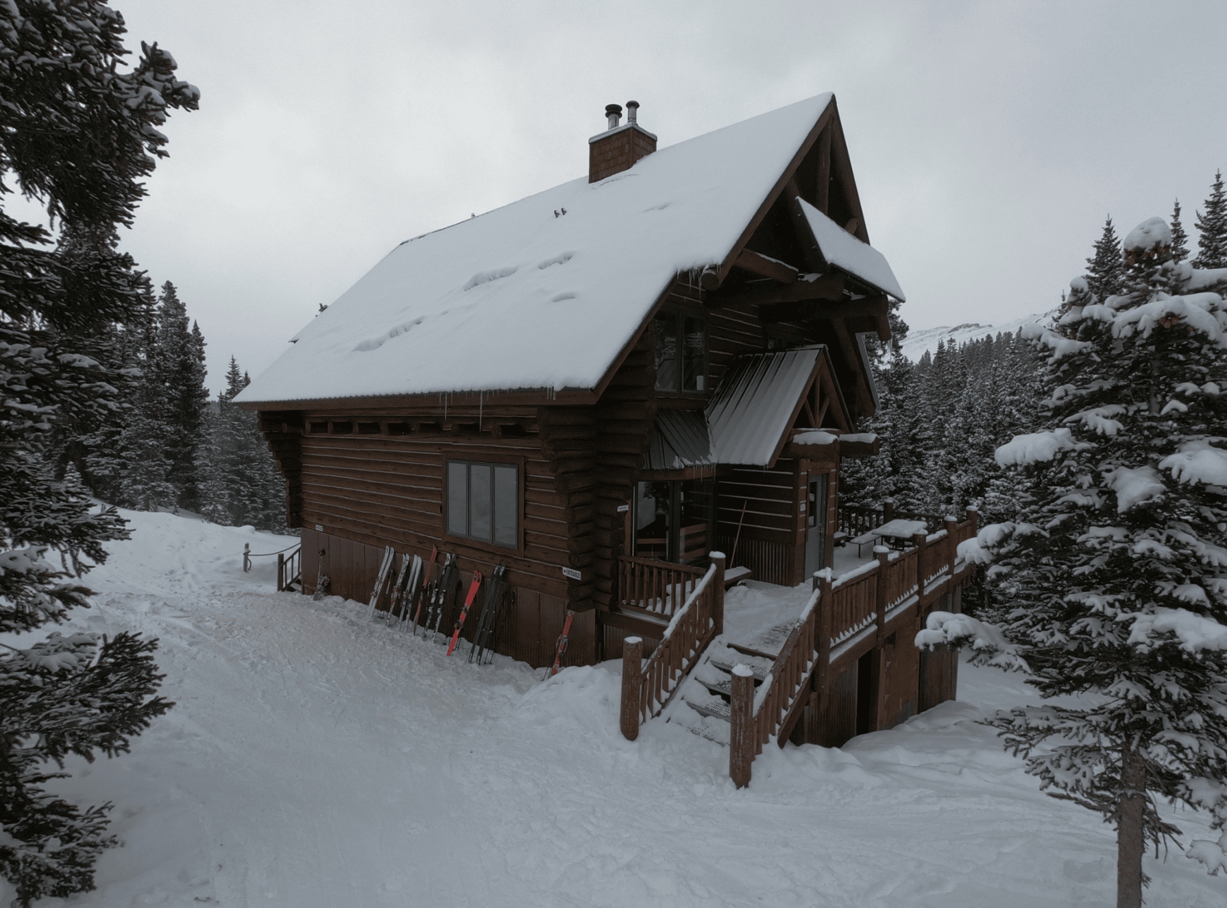 Snow covering a cabin in the woods