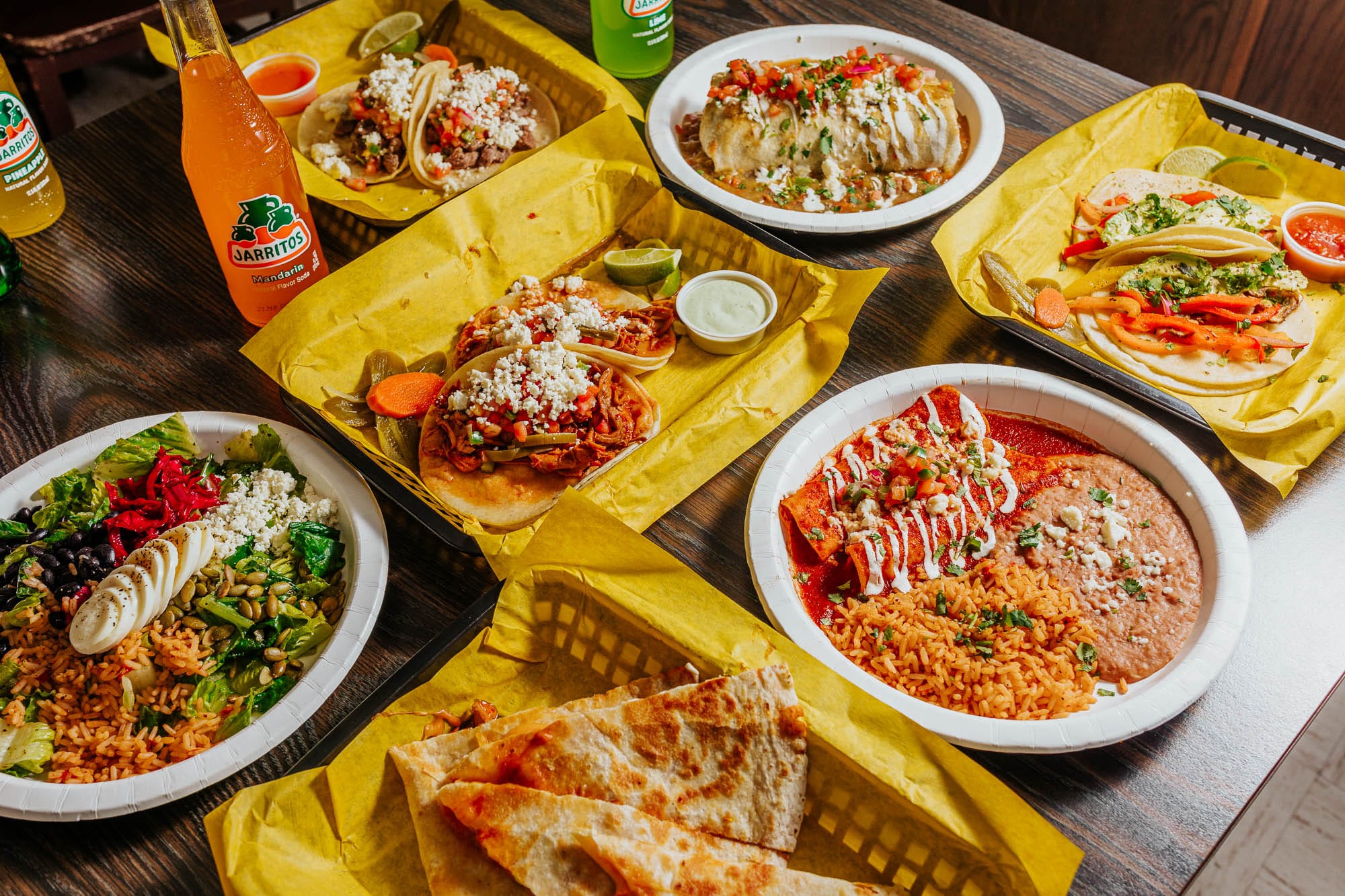 Multiple plates of Mexican food