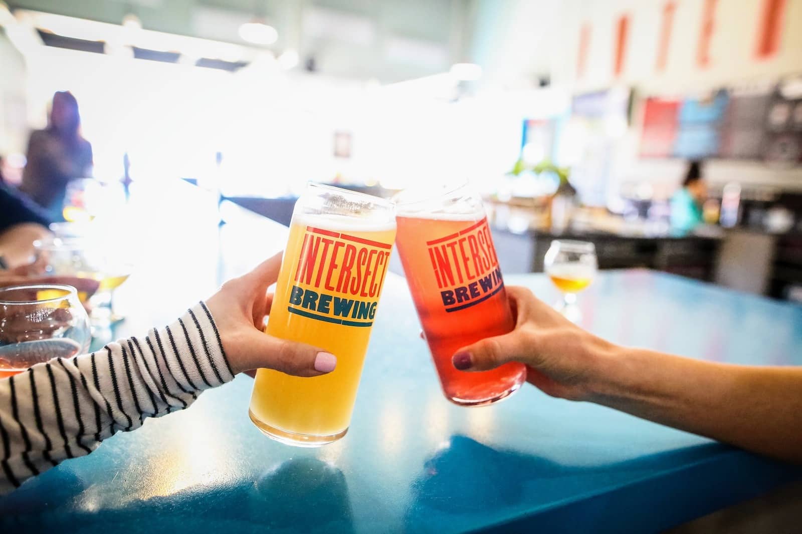 Image of people cheering glasses together at Intersect Brewing in Fort Collins, Colorado