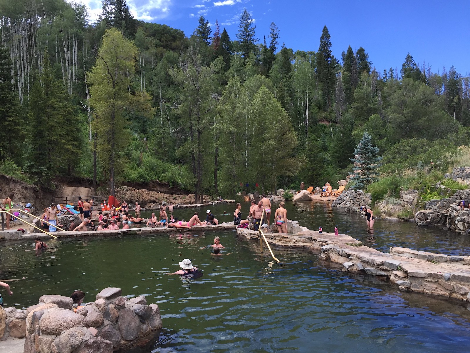 Image of people soaking in the pools at Strawberry Park Hot Springs in Steamboat Springs, Colorado