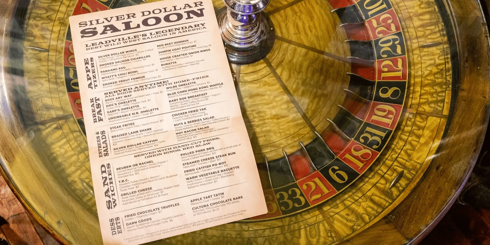 Image of the menu and a roulette table at The Legendary Silver Dollar Saloon in Leadville, Colorado