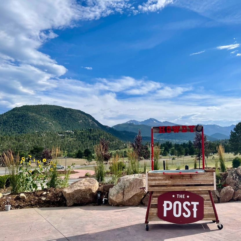 The Post Chicken and Beer sign in front of mountains