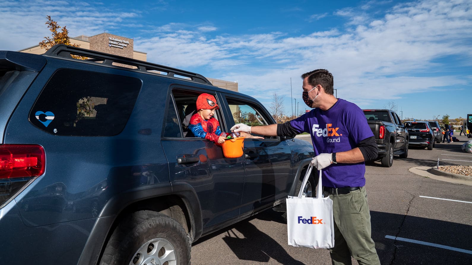 Person handing child candy for halloween