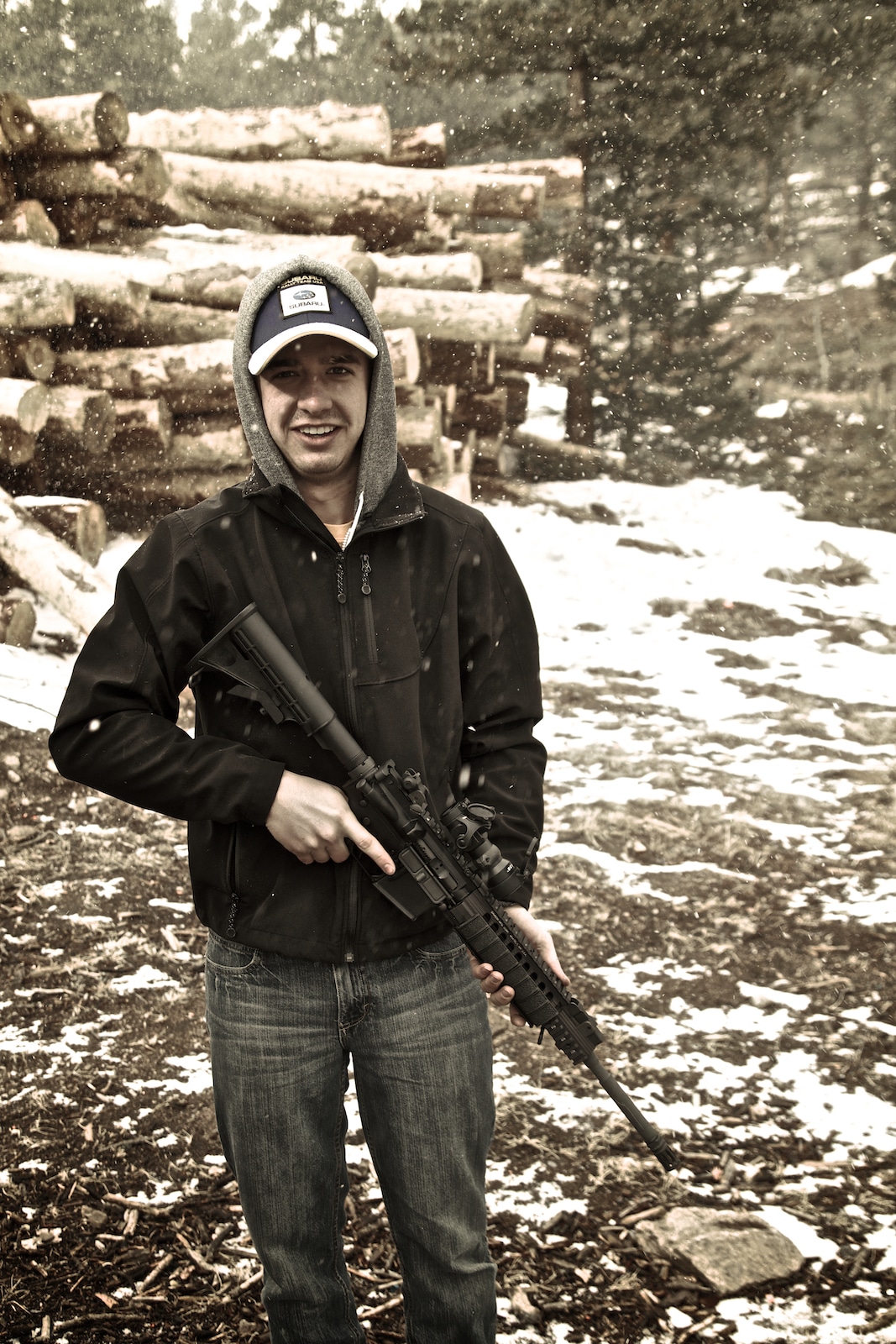 Guy holding Sabre Defense .223 AR-15 service rifle in Colorado mountains