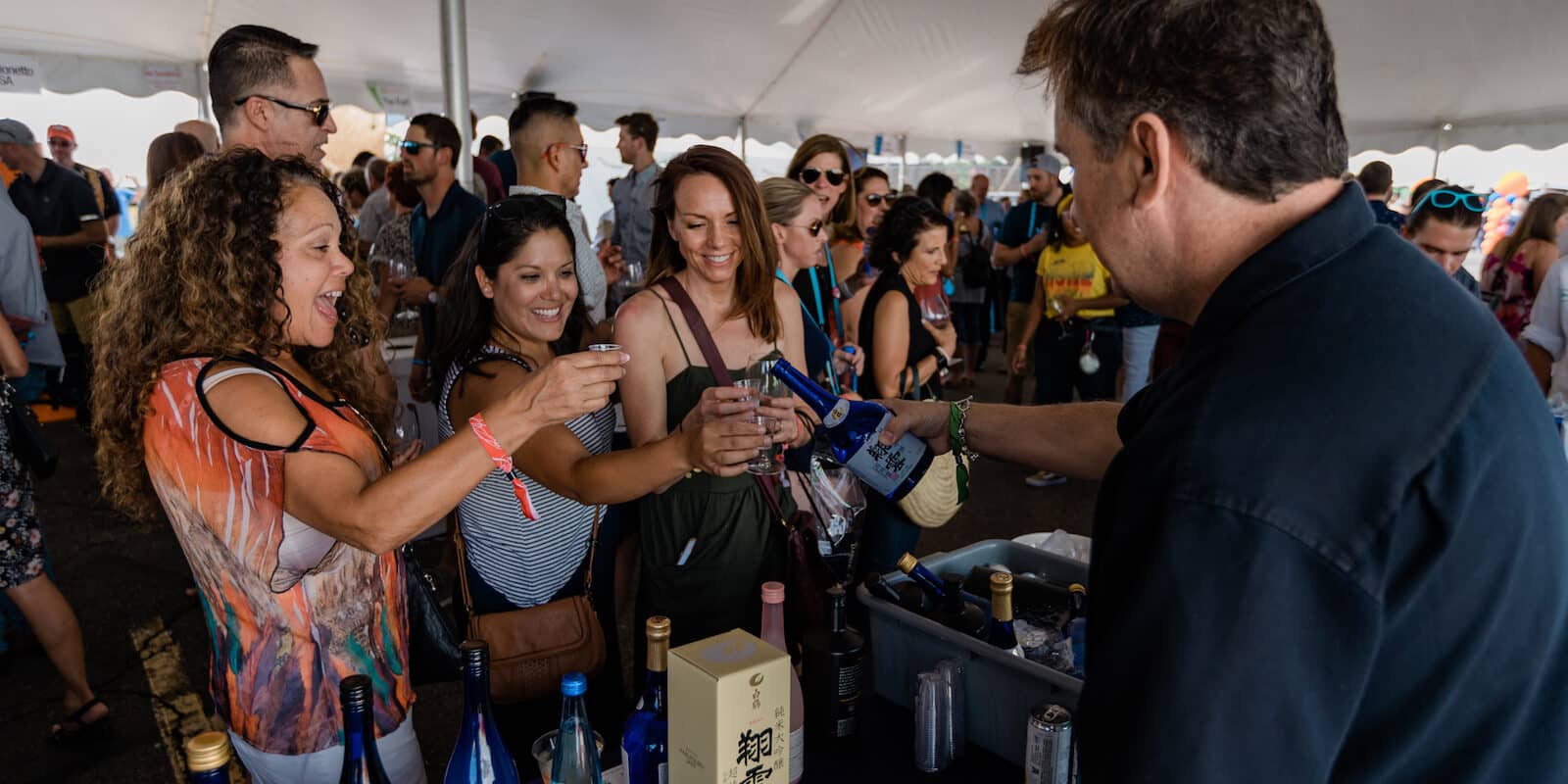 Image of women sampling sake at the Denver Food & Wine Festival in Colorado