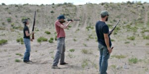 Three people shooting rifles in Crestone, Colorado