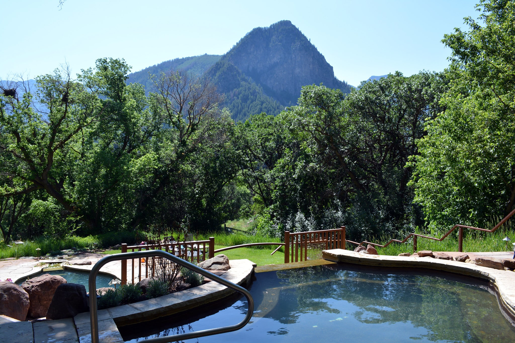 Commercialized hot spring pool with mountains in background