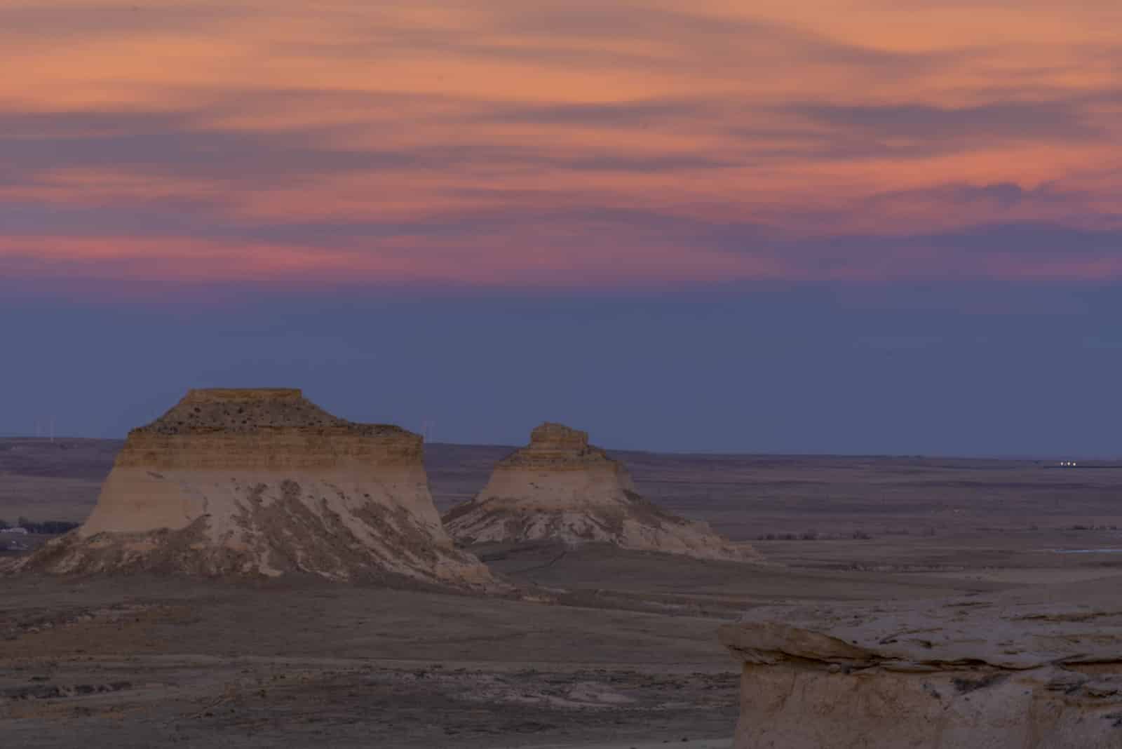 Sunset over grasslands with buttes