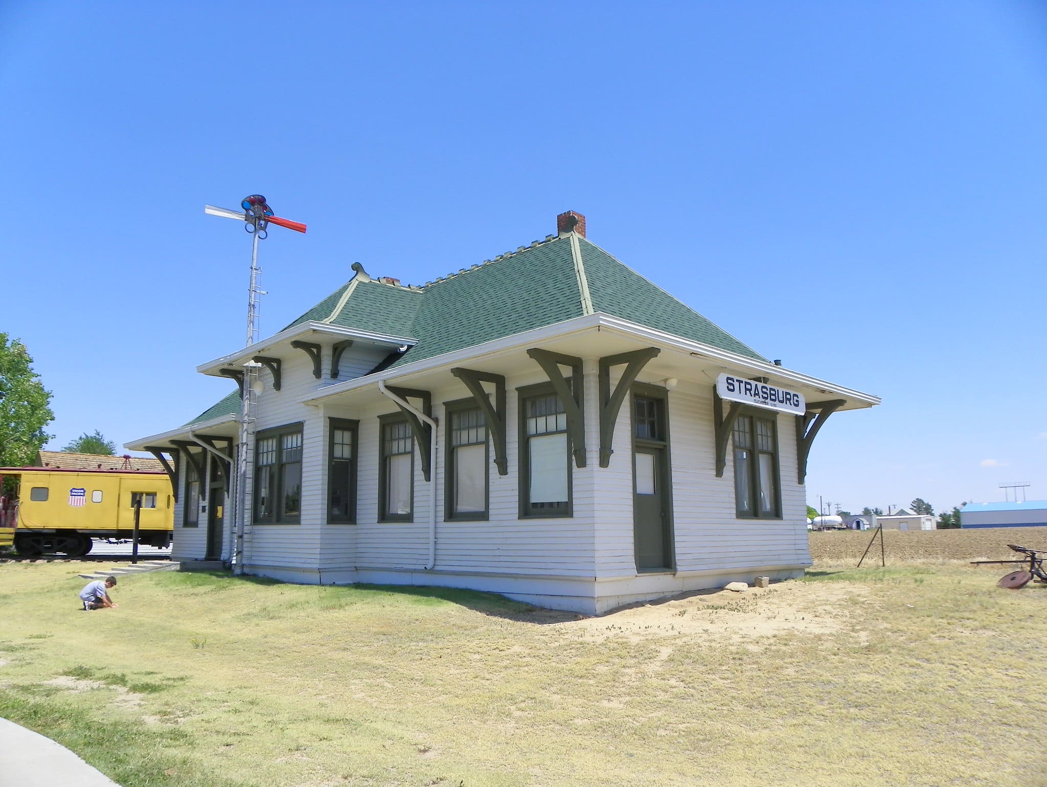 Historic train depot, white wooden building with green roof