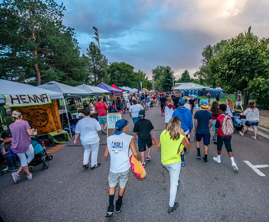 Festival visitors walking through vendors