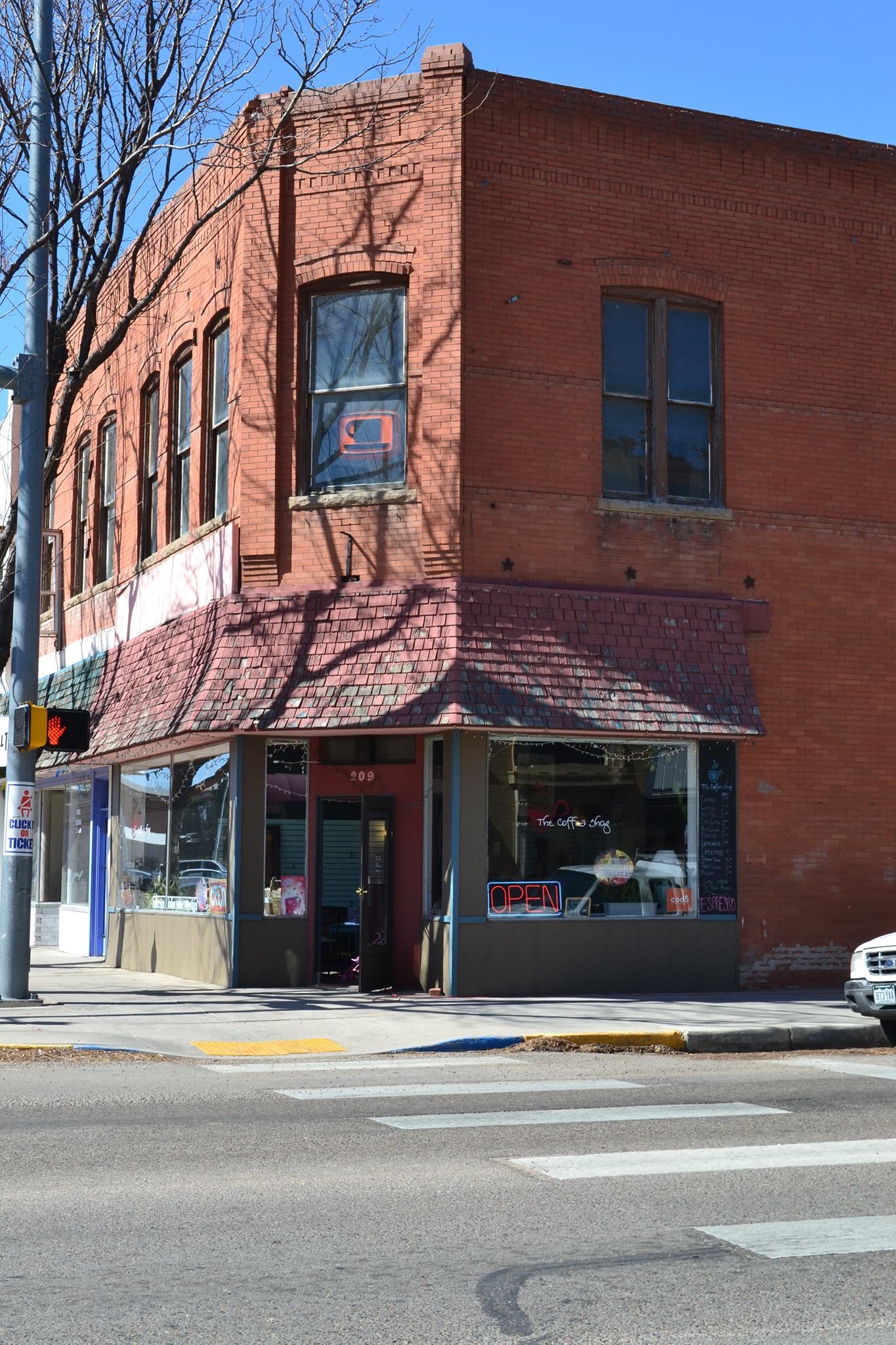 Red brick building with a coffee shop on the bottom floor