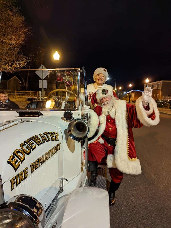 Mr and Mrs. Santa Claus in an old fire engine