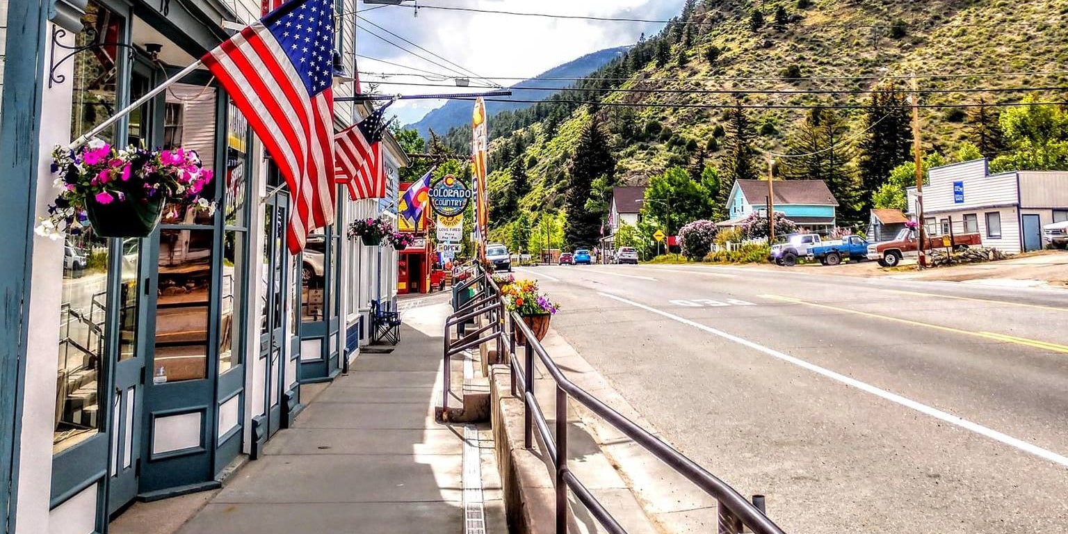 Main street of small town with American flag hanging down