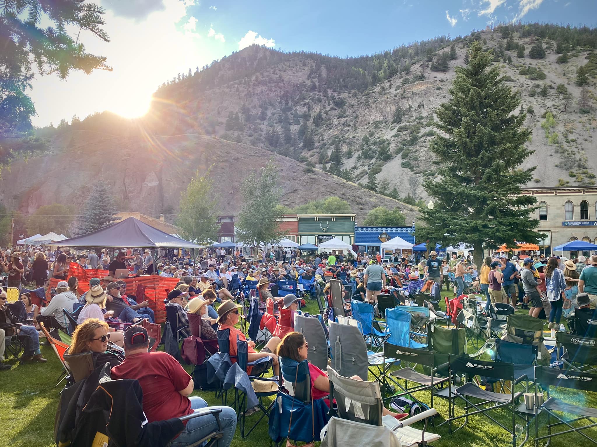 Huge crowd on a lawn in Lake City enjoying live music at the Lake City Uncorked Wine & Music Festival.