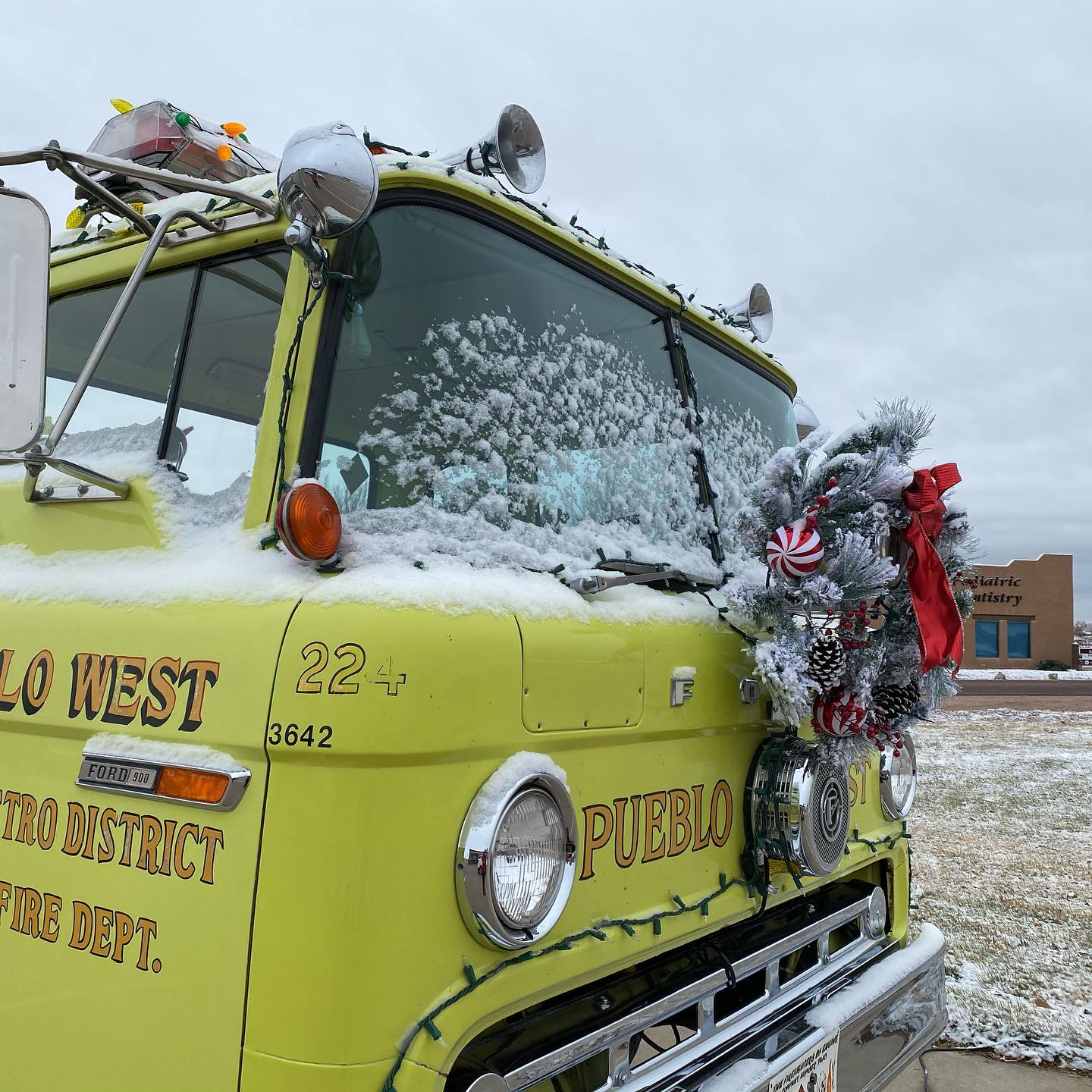 Yellow fire truck decorated with wreath