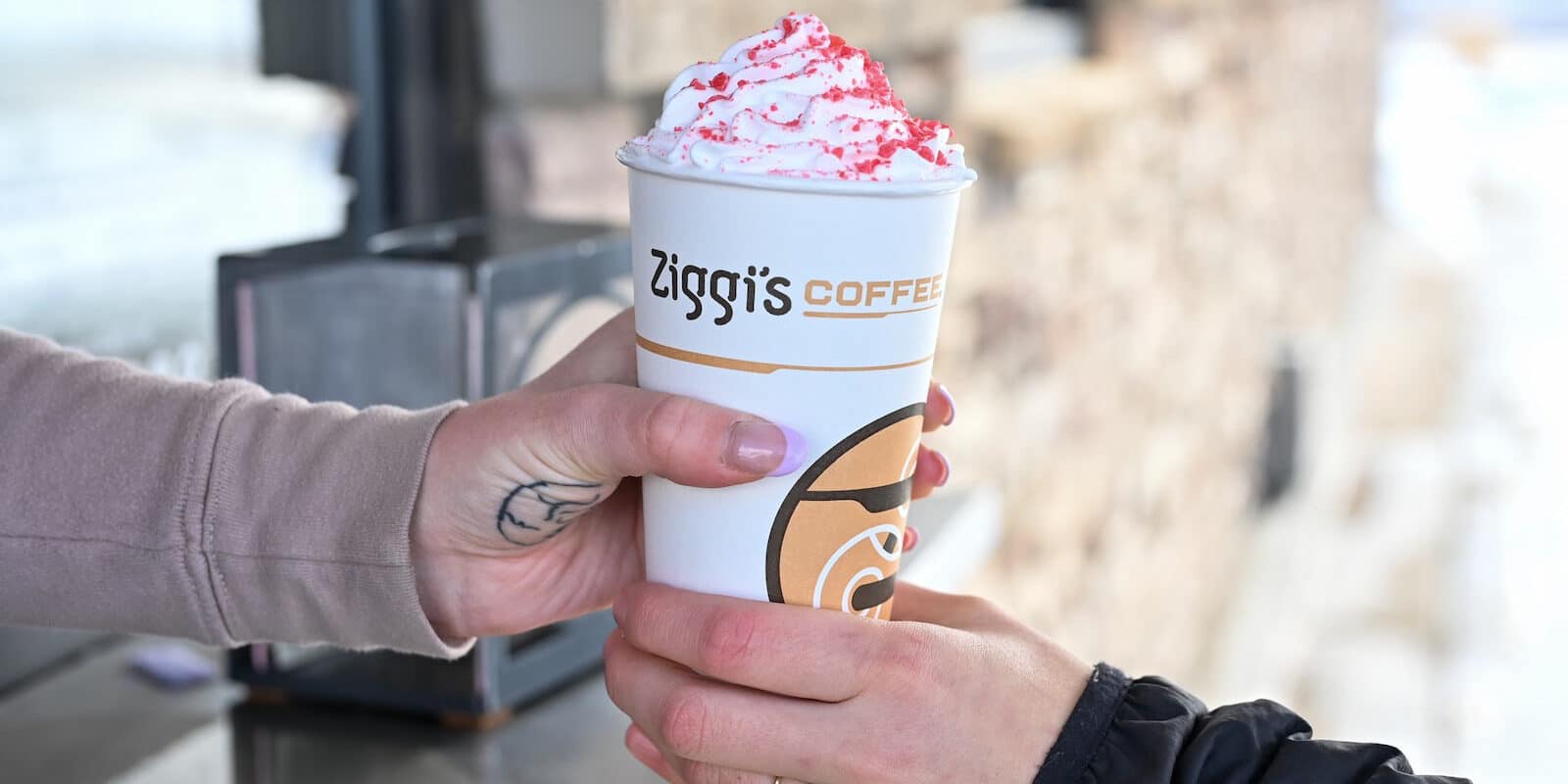 Image of a person getting a coffee in the drive thru of Ziggi's Coffee