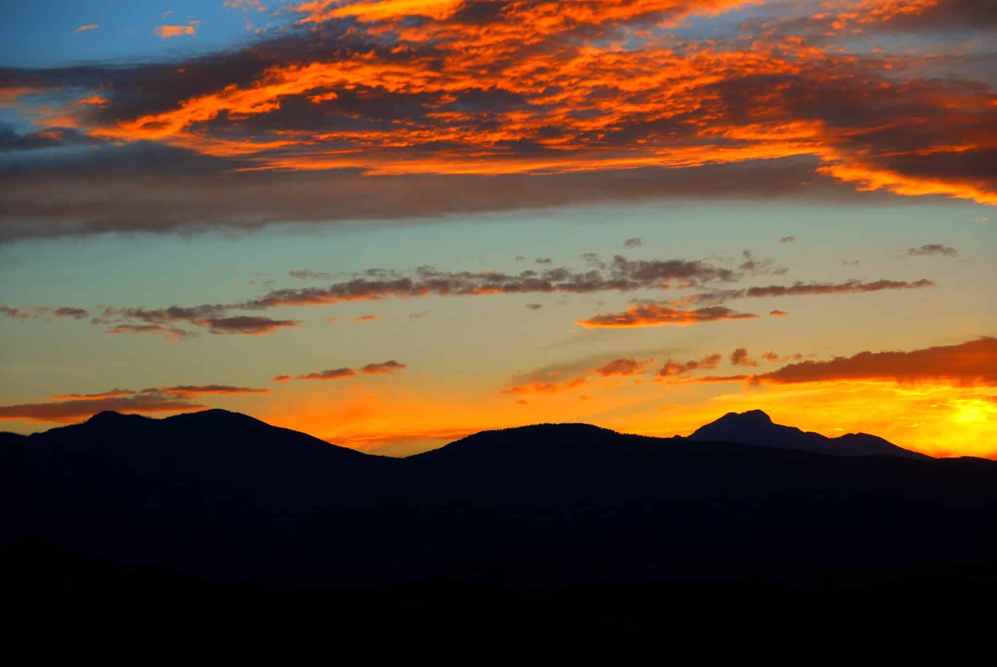 Sunset over the silhouette of a mountain range 