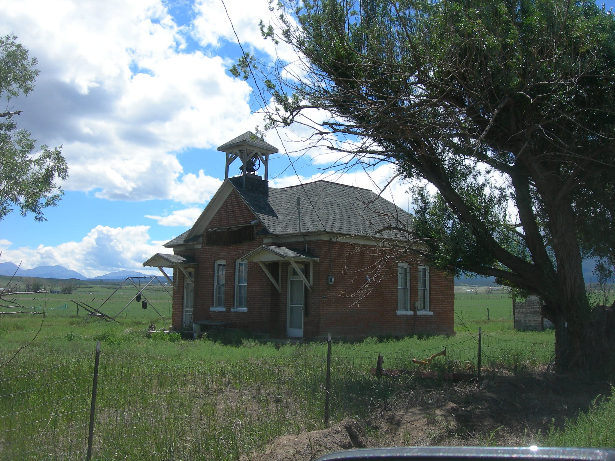 Historic schoolhouse in field