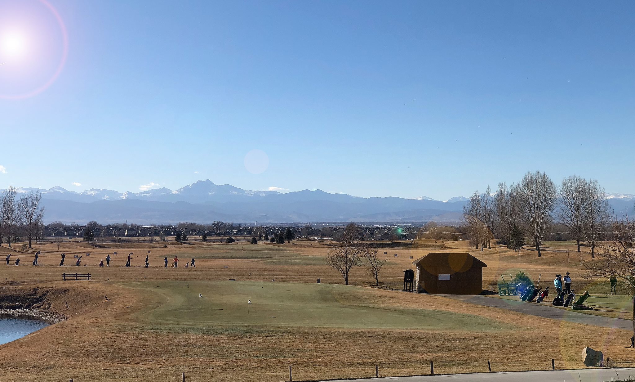 Sunny day over a golf course with mountains in the back