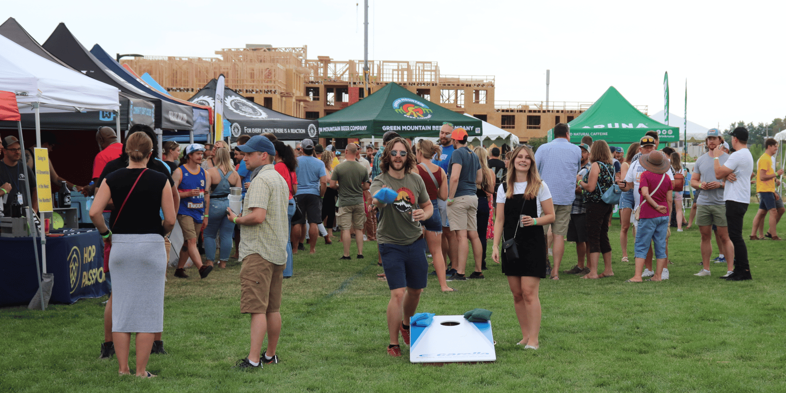 Community members enjoying ThirstyFest 2021 by playing cornhole and tasting locally crafted beverages