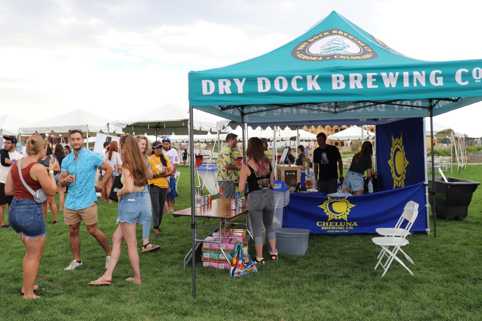 ThirstyFest attendees gather around the Dry Rock Brewing Co. tent while sampling beverages.