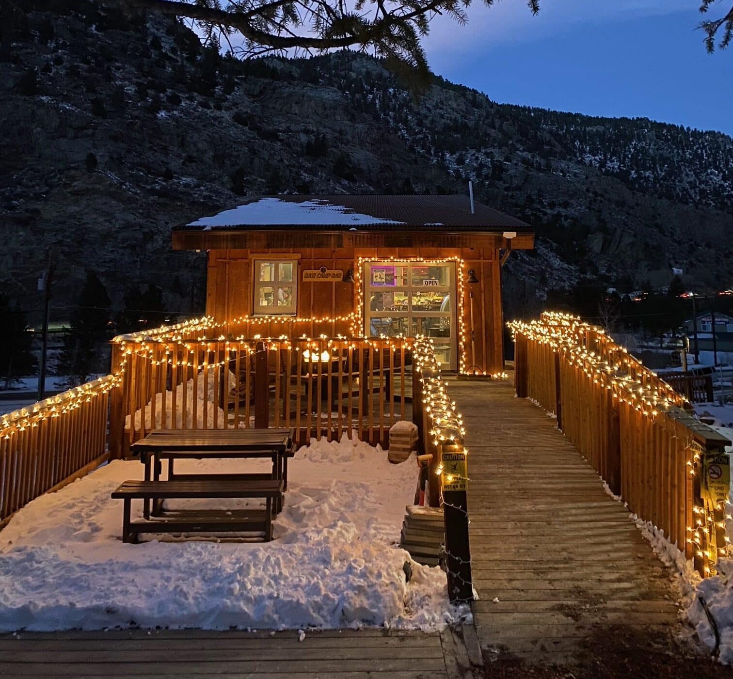 Small restaurant and bar with twinkle lights on wooden deck