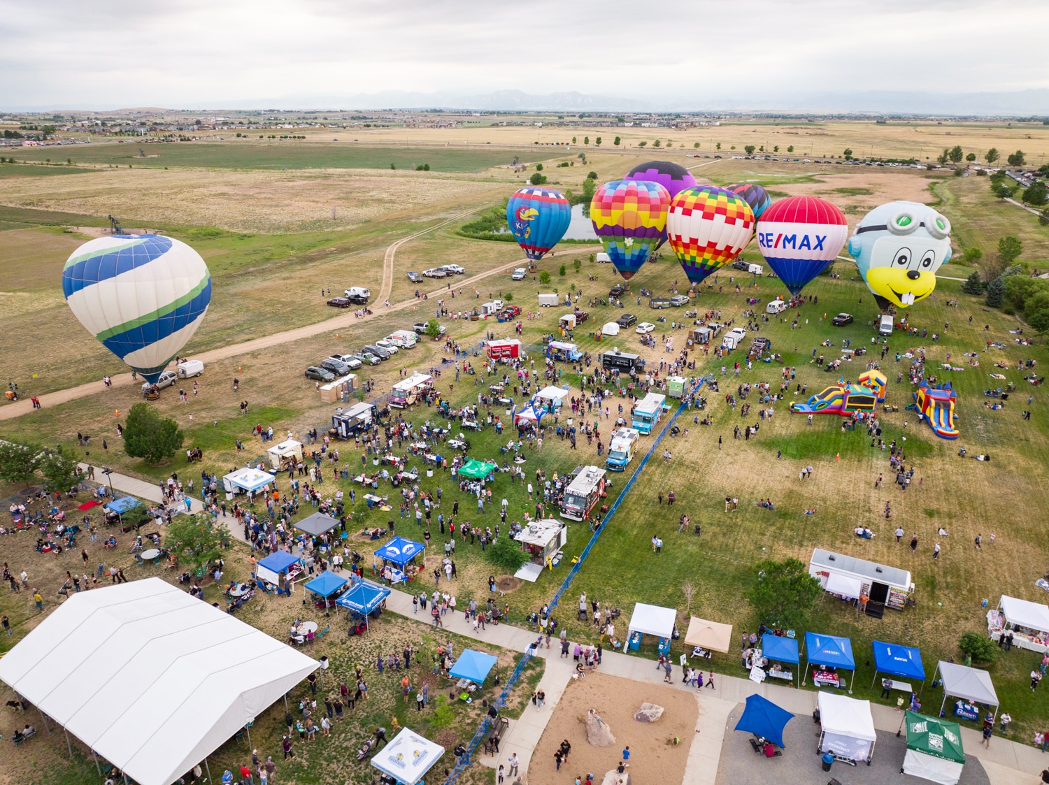 Aerial view of city park with hot air balloon festival 