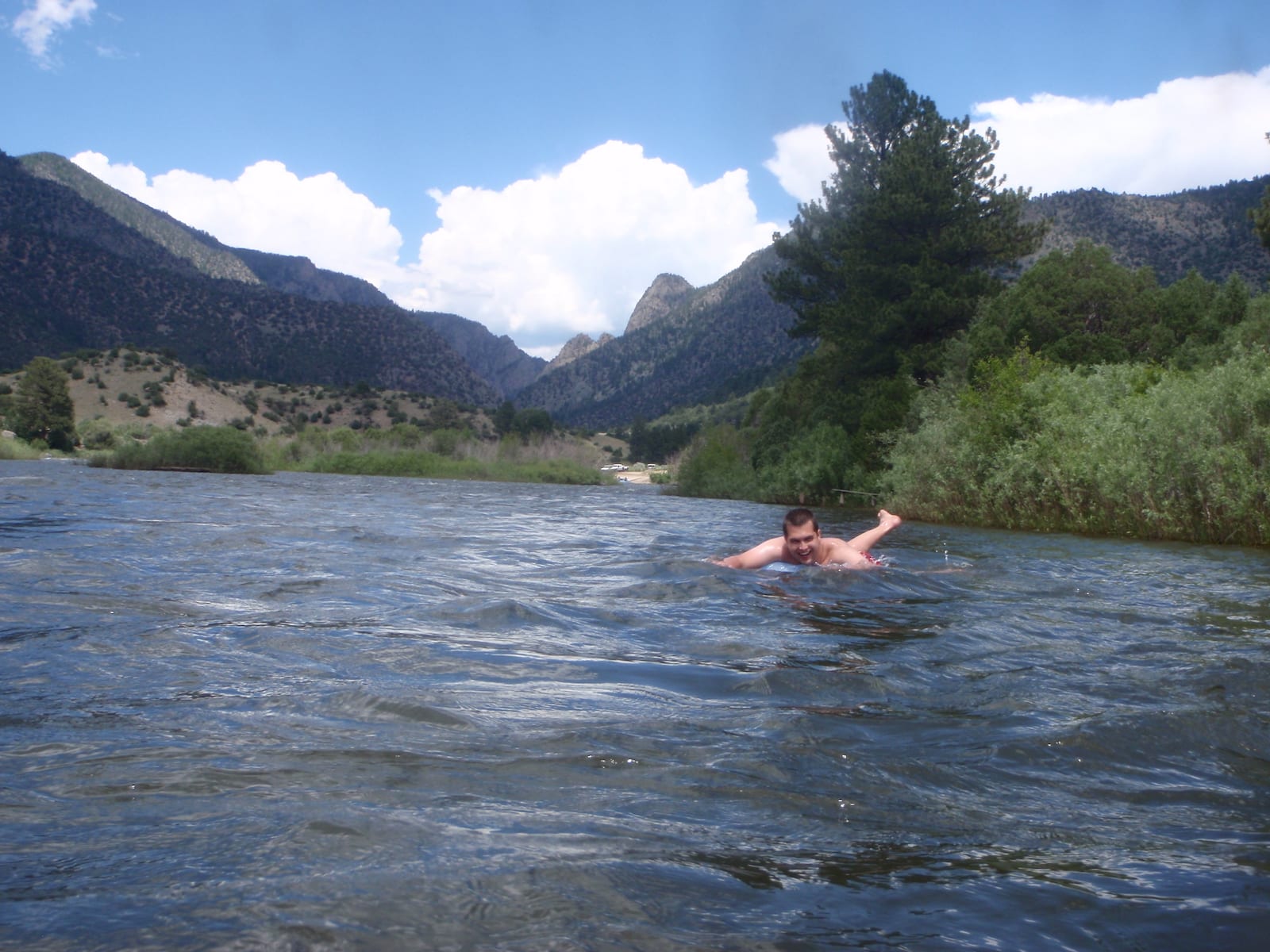 Tuber floating belly down on the Colorado River by Radium