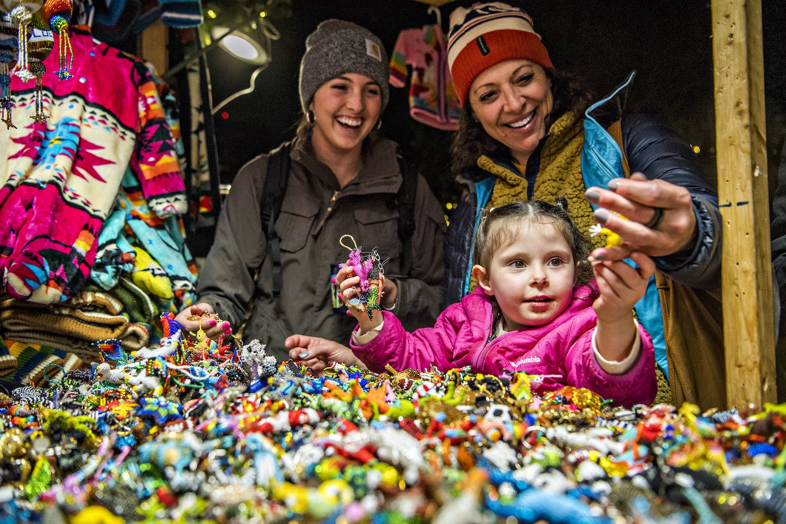 Denver Christkindlmarket little girl looks at keychains