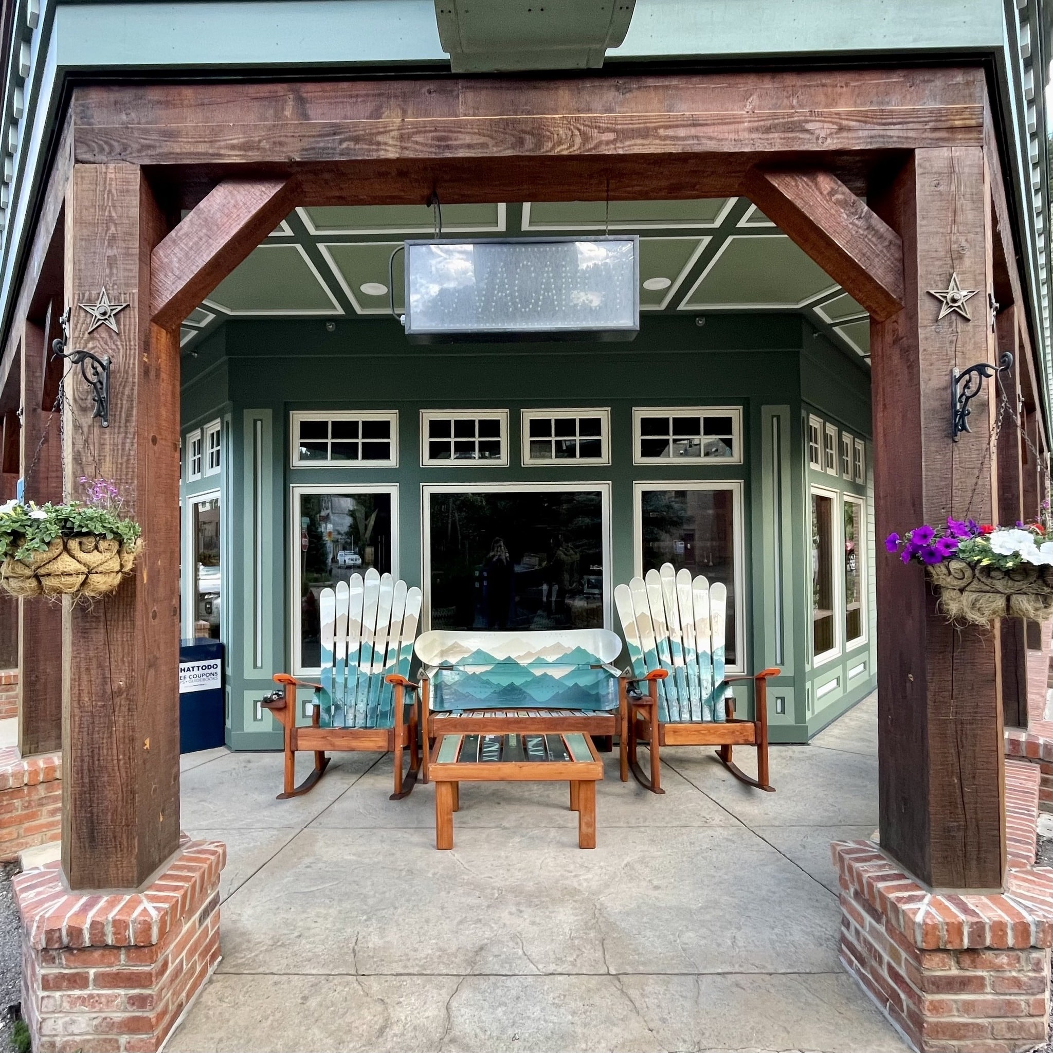 Entrance to hotel with two Adirondack chairs