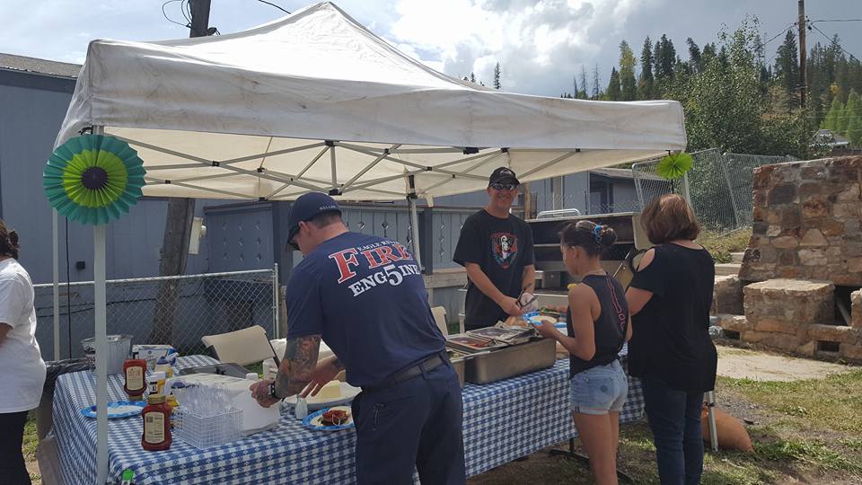 Firefighters handing out food to visitors at a festival