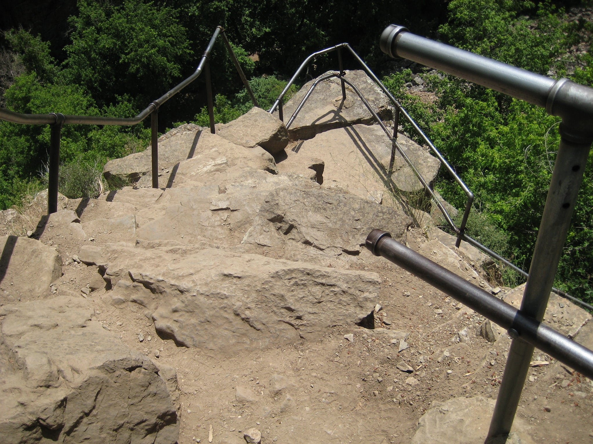 Stairs made of rock with metal railings