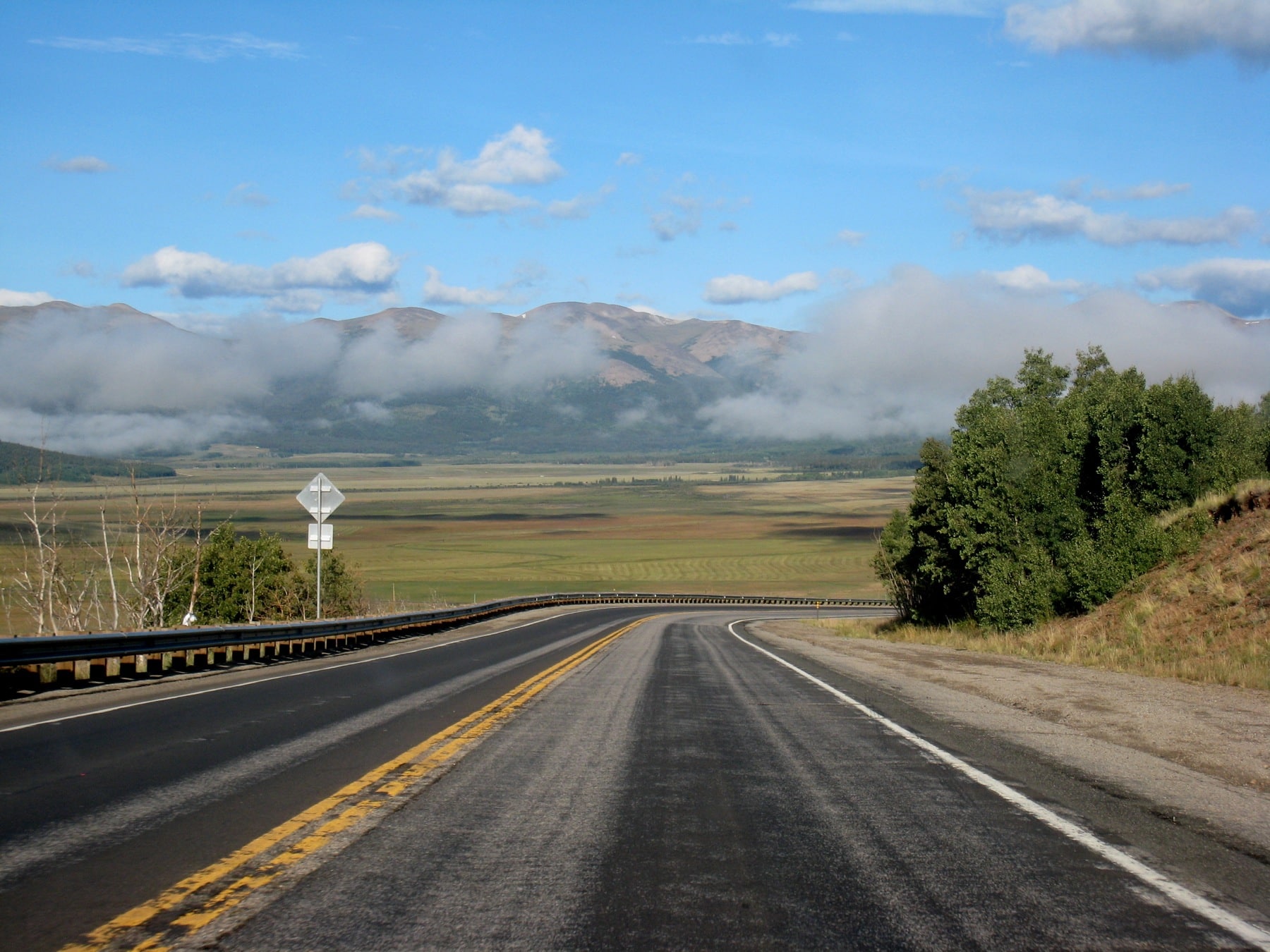 Highway heading toward mountains on a clear day