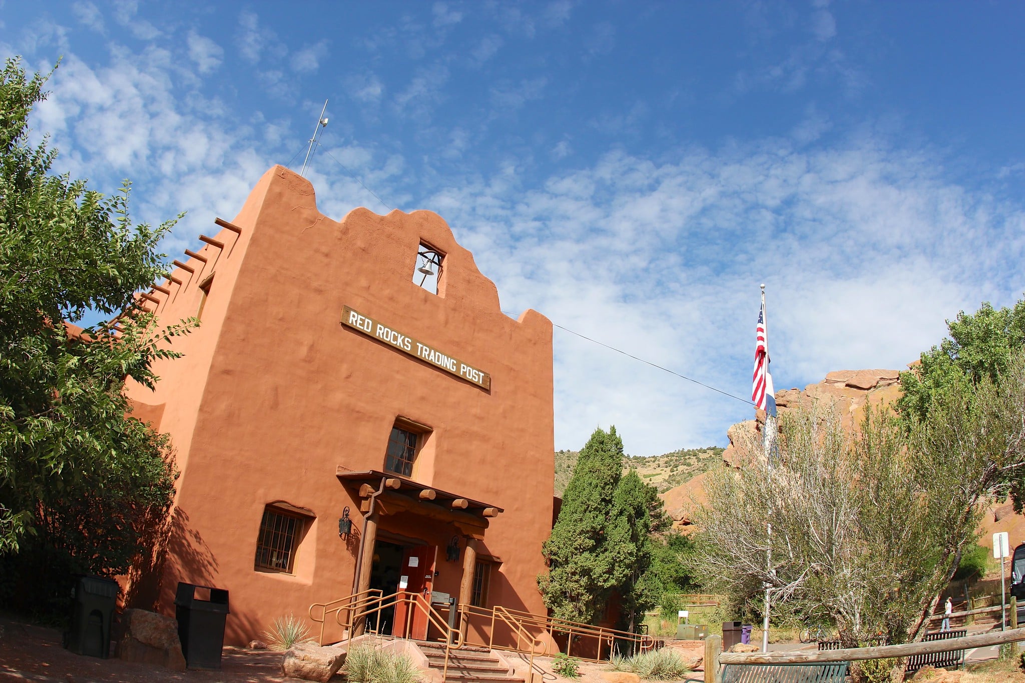 Red adobe trading post building with blue skies in the background at Red Rocks Amphitheatre and Park