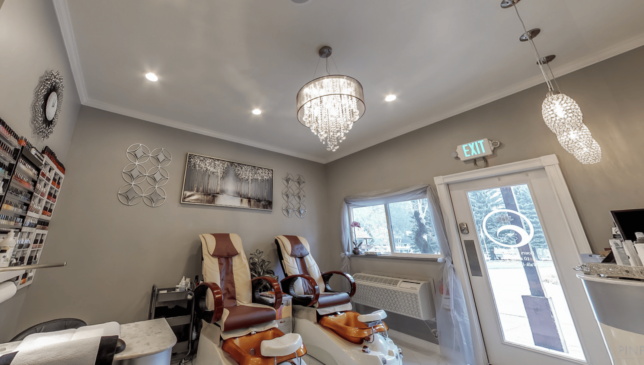 Two pedicure chairs in a bright spa room