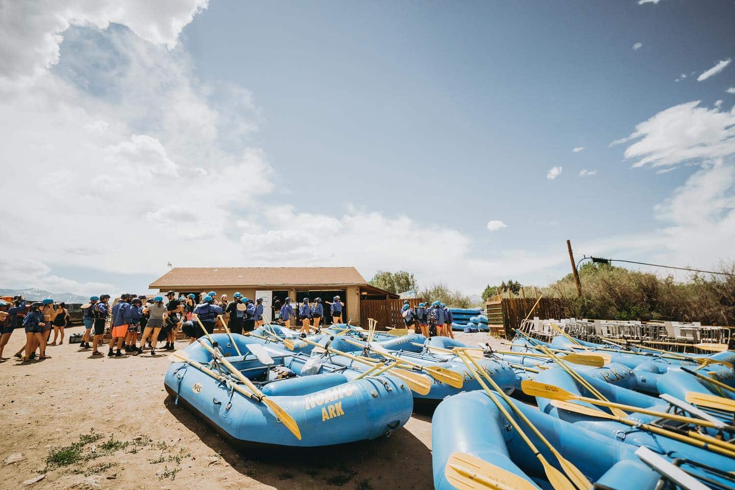 Blue whitewater rafts sitting on the ground in front of Noah's Ark Rafting