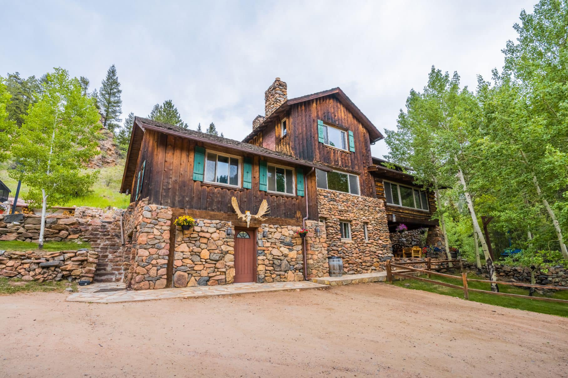 Large wooden and stone lodge in the forest