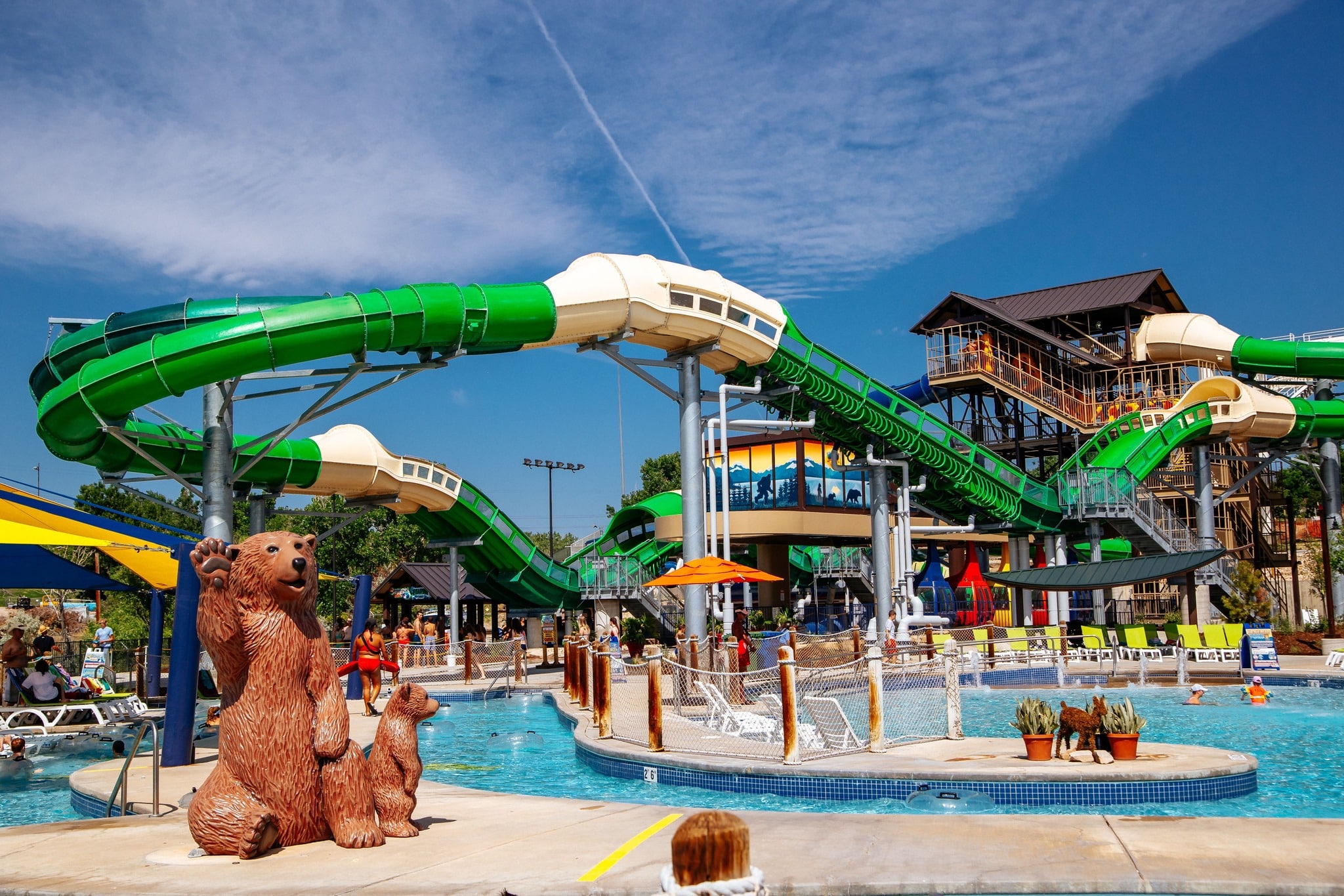 Huge waterpark attractions with large green slide and lazy river at Water World