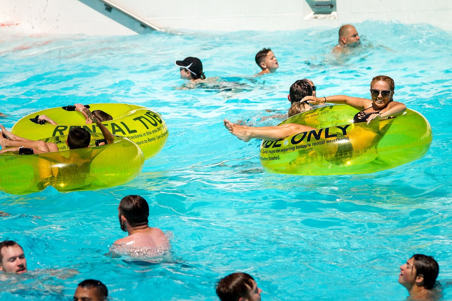 People on yellow tubes in the wave pool at Water World