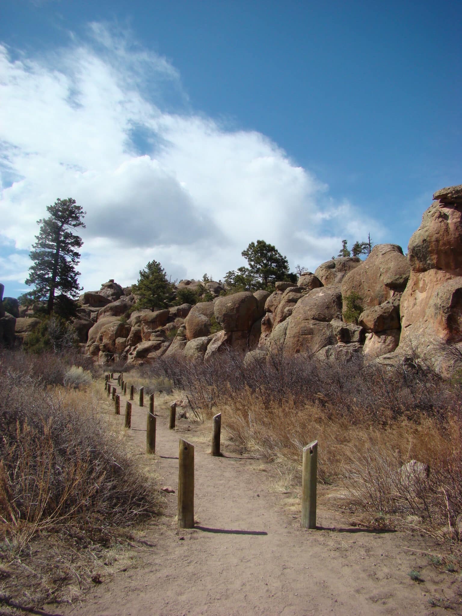 Walking trail next to medium sized rock formations