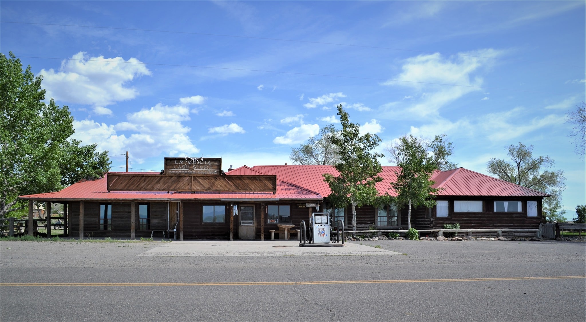 One-story building with a red roof on the side of the road