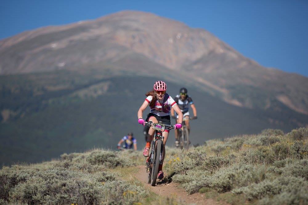 Three bikers on mountain biking trail during race through a high elevation course