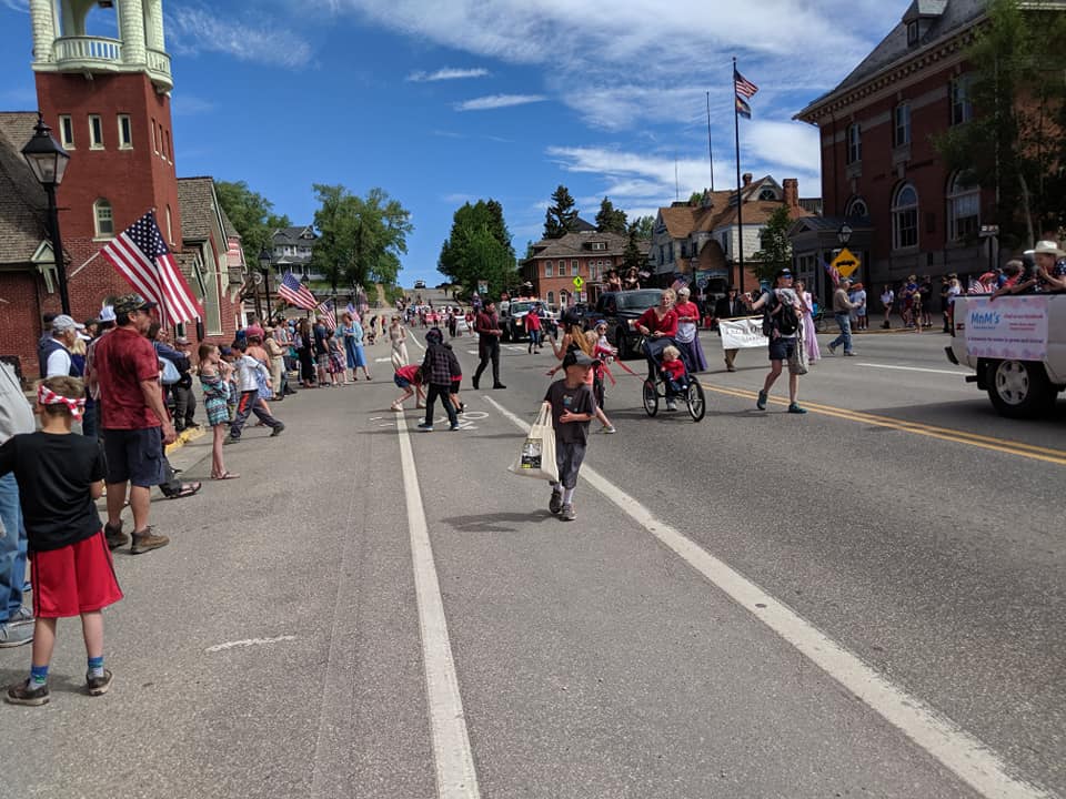 Parade down main street of small town on a sunny day