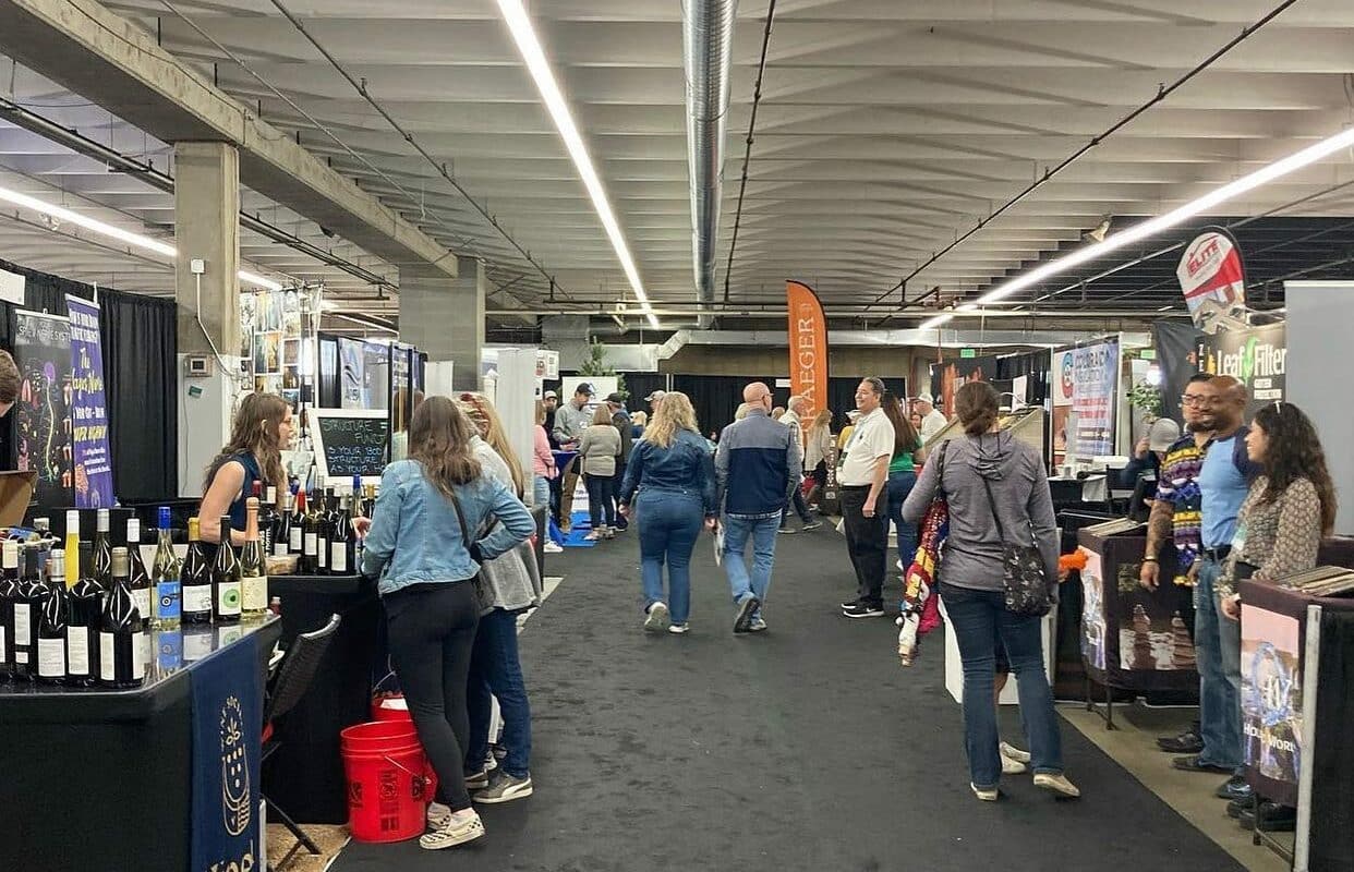 Walkway at a home renovation show with several company booths