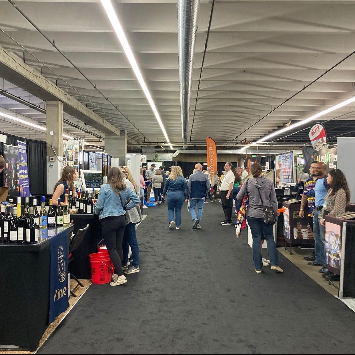 Walkway at a home renovation show with several company booths