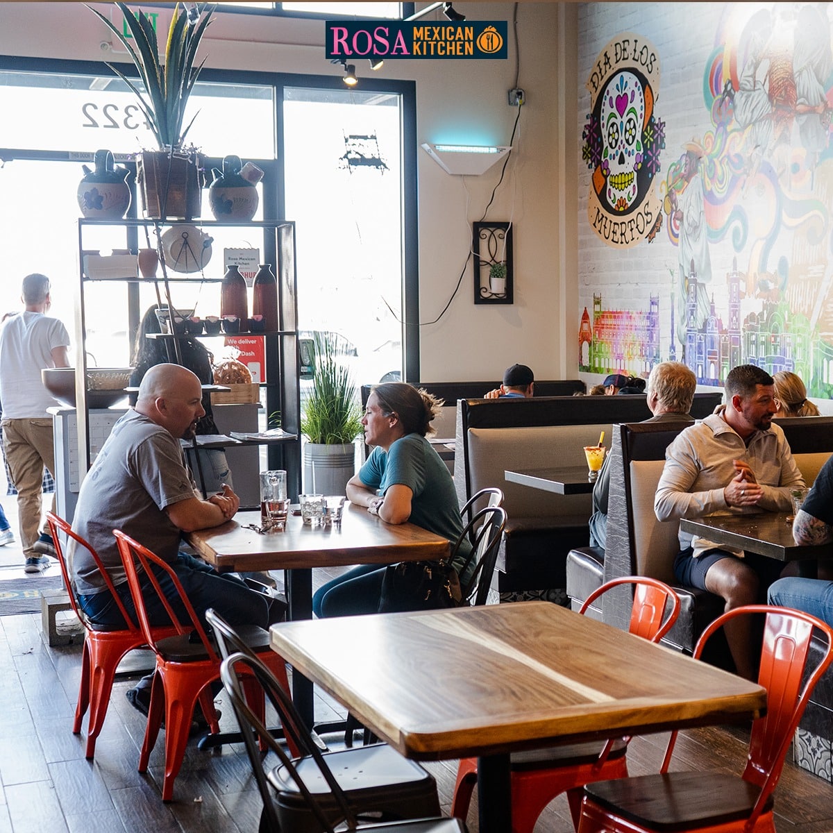 People sitting at tables in a restaurant 